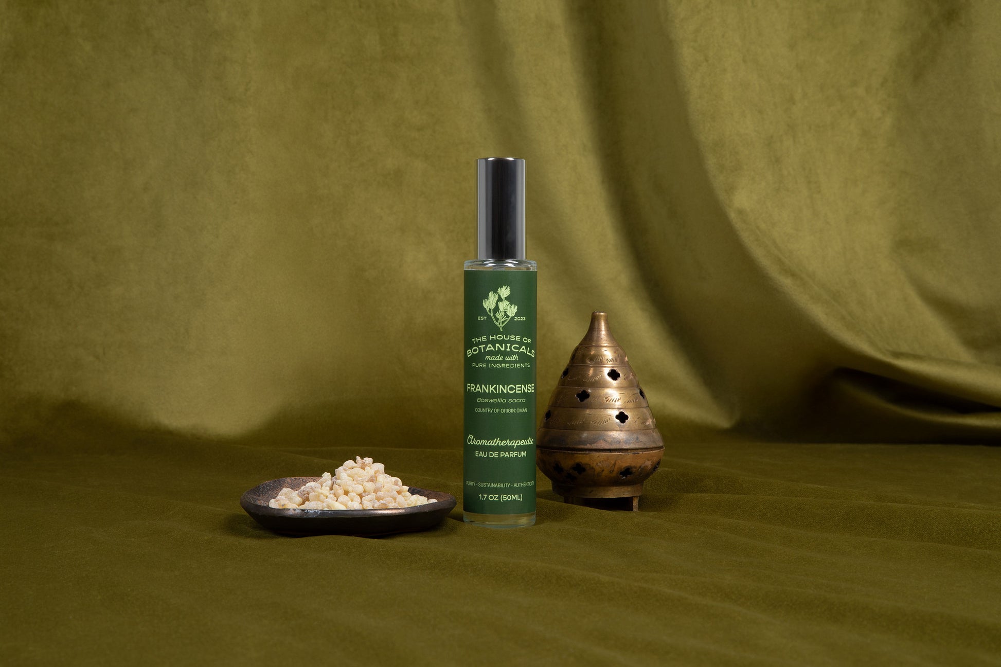 Frankincense aromatherapeutic ritual spray bottle styled with botanicals in natural light